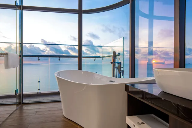 Oceanfront bathtub and coastline views in a Premier Suite